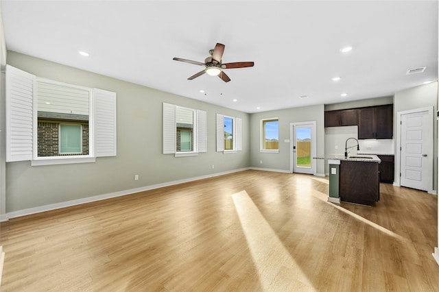 unfurnished living room featuring light wood-style floors, recessed lighting, baseboards, and a ceiling fan