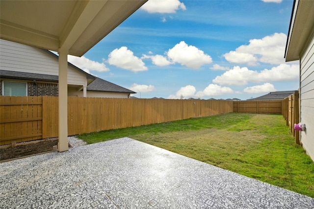 view of yard with a patio area and a fenced backyard