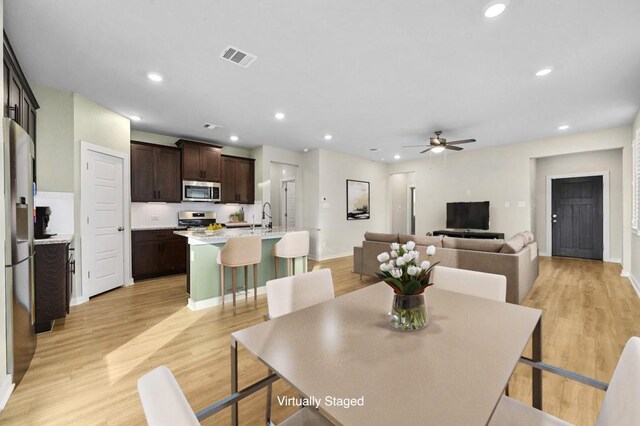 dining room with ceiling fan, light wood-type flooring, visible vents, and recessed lighting