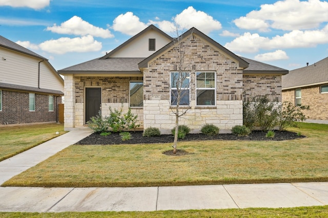 107 Dedina Dr, Georgetown, TX 78626 - view of front of property with stone siding, a front lawn, and roof with shingles