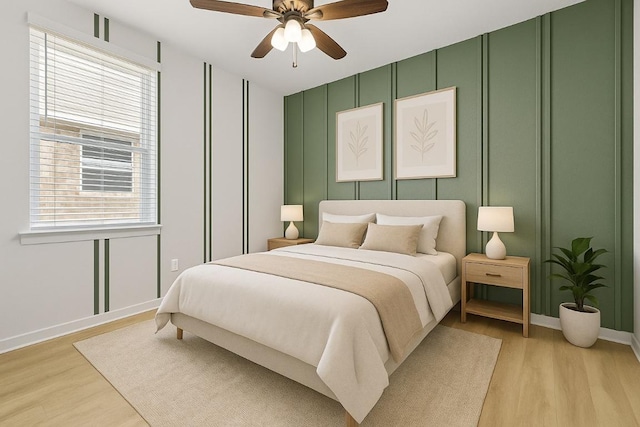107 Dedina Dr, Georgetown, TX 78626 - bedroom with multiple windows, light wood-style flooring, a decorative wall, and a ceiling fan