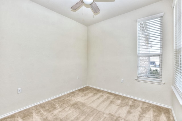 unfurnished room with ceiling fan and light carpet