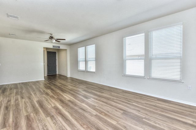 unfurnished room featuring ceiling fan and hardwood / wood-style flooring