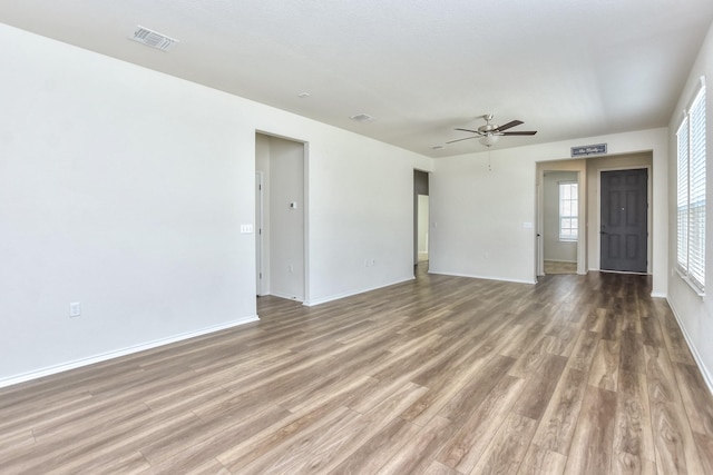 empty room featuring ceiling fan and hardwood / wood-style flooring