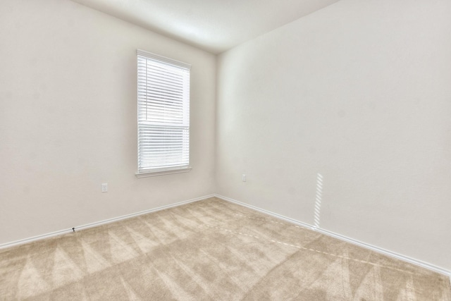 unfurnished room featuring light carpet