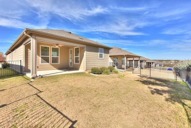 back of property featuring ceiling fan, a patio area, and a yard