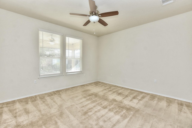 empty room with light carpet and ceiling fan