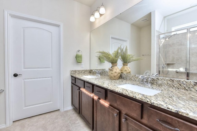 716 Kitty Hawk Rd, Georgetown, TX 78633 - full bathroom featuring double vanity, a tile shower, and tile patterned floors