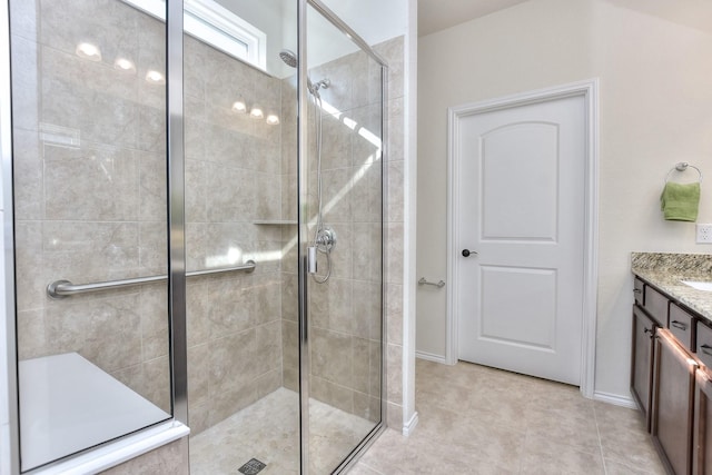 bathroom with a shower with shower door and vanity