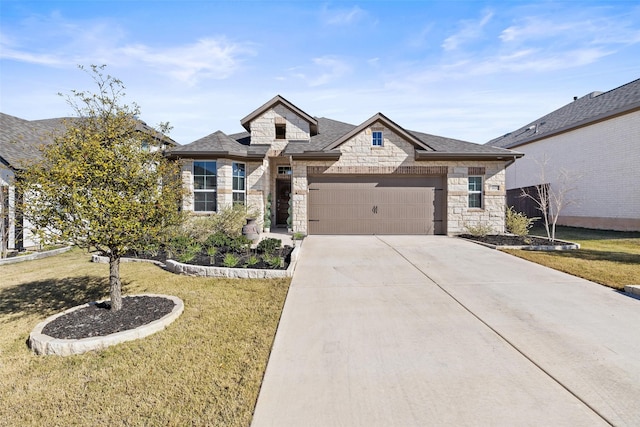 view of front of home with a front yard and a garage