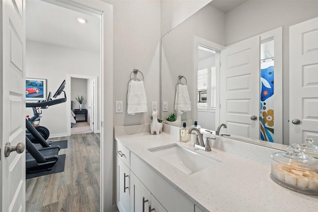 bathroom featuring hardwood / wood-style flooring and vanity