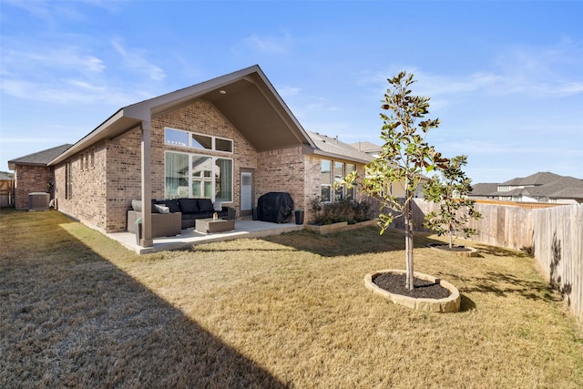 rear view of property with a yard, a patio, and central AC