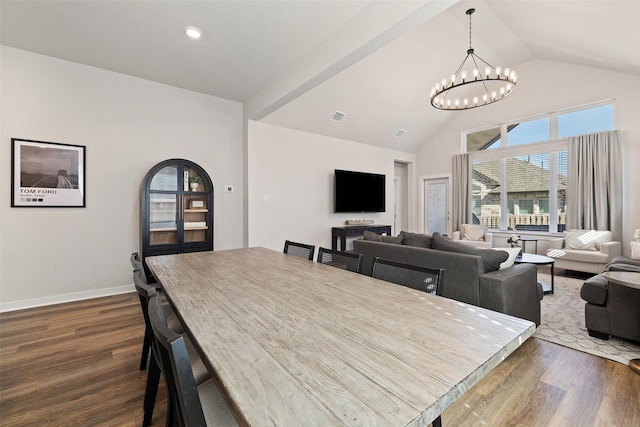 dining room with dark hardwood / wood-style flooring, lofted ceiling, and a notable chandelier