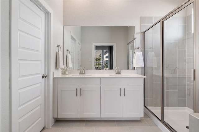 bathroom with vanity, tile patterned floors, and walk in shower