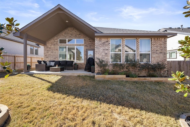 rear view of house with an outdoor hangout area, a yard, and a patio