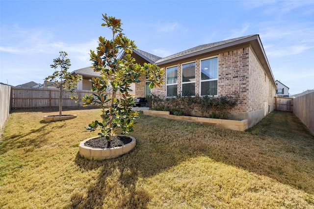 rear view of house with a yard