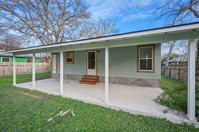 rear view of house featuring a yard