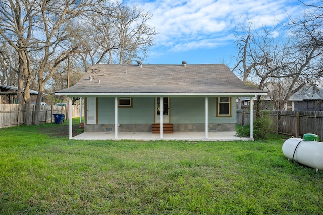 rear view of property featuring a yard and a patio