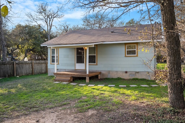 back of property featuring a lawn