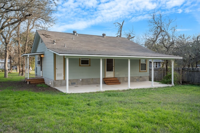 back of house with a patio area and a lawn