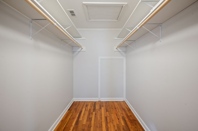 walk in closet with wood-type flooring