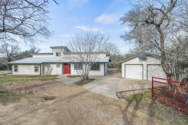 view of front facade featuring a garage and an outdoor structure