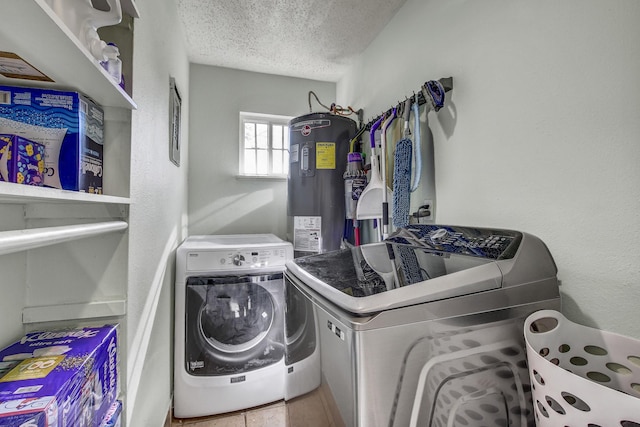 clothes washing area with water heater, separate washer and dryer, and a textured ceiling