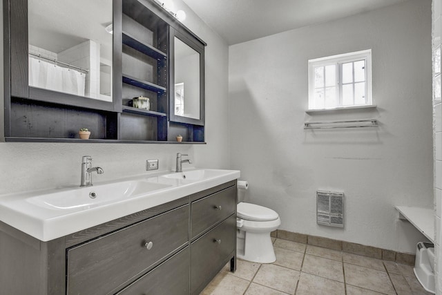 bathroom featuring toilet, vanity, and tile patterned floors