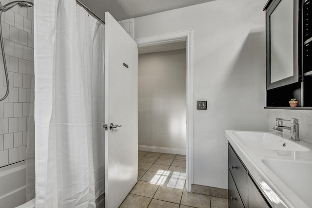 bathroom featuring shower / bathtub combination with curtain, tile patterned floors, and vanity