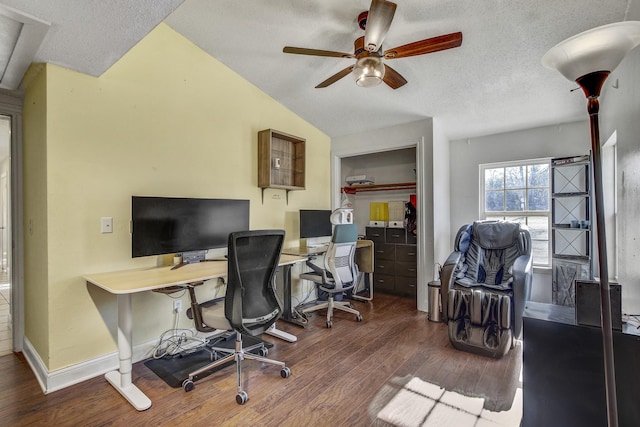 home office featuring ceiling fan, dark wood-type flooring, a textured ceiling, and lofted ceiling