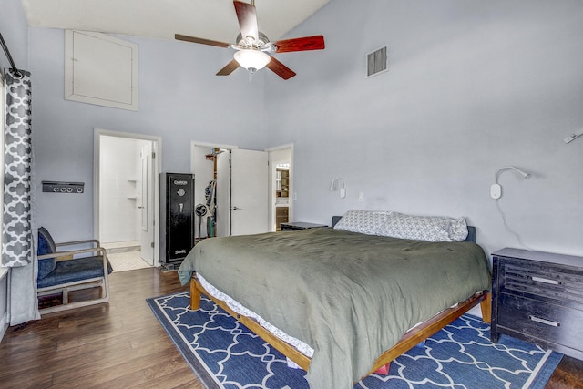 bedroom featuring ceiling fan, connected bathroom, dark hardwood / wood-style floors, and high vaulted ceiling