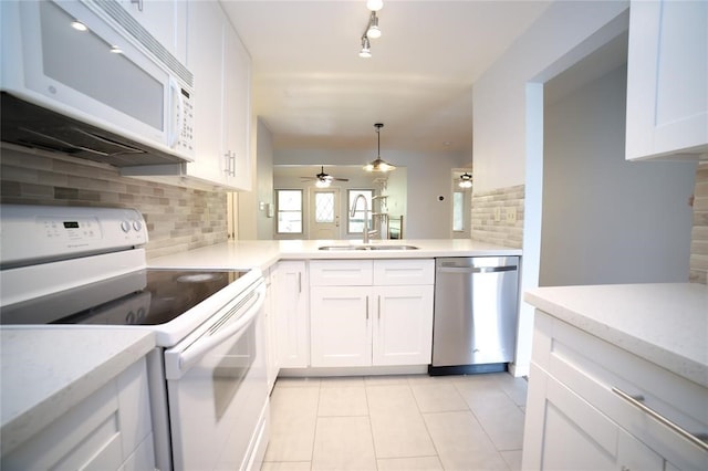 kitchen featuring ceiling fan, sink, white appliances, and white cabinetry