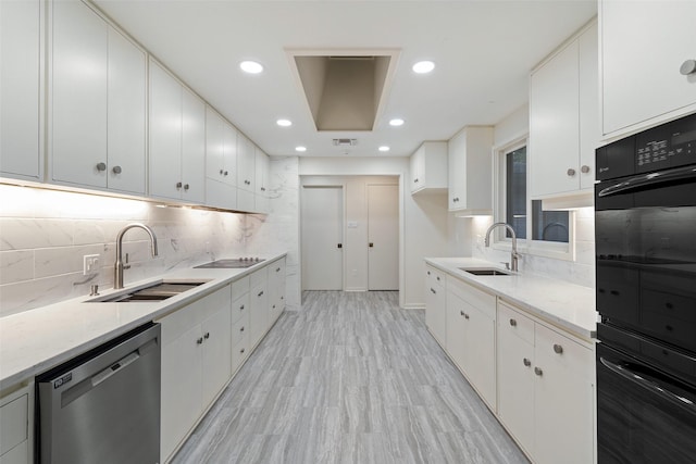 kitchen with sink, white cabinets, and black appliances