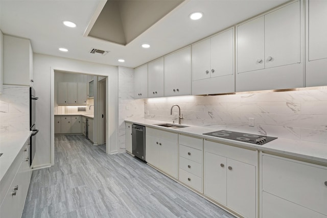 kitchen featuring light hardwood / wood-style floors, sink, white cabinetry, and stainless steel appliances