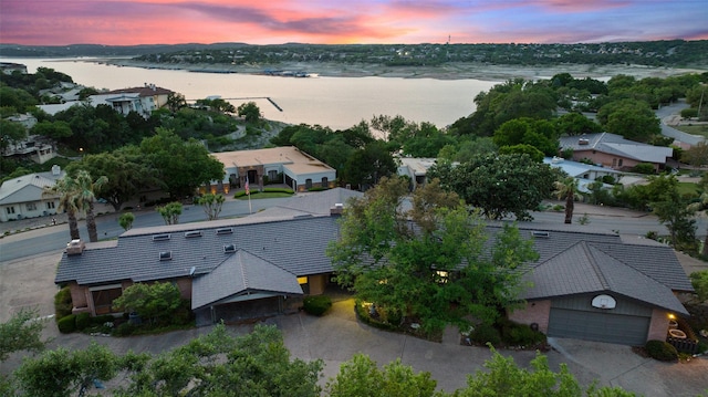 aerial view at dusk with a water view