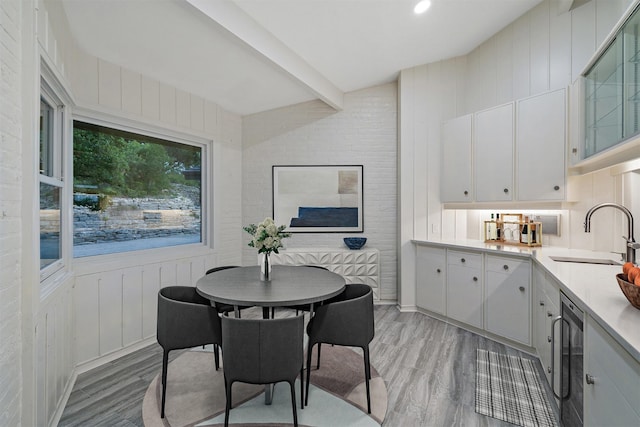 dining room featuring sink and light hardwood / wood-style flooring