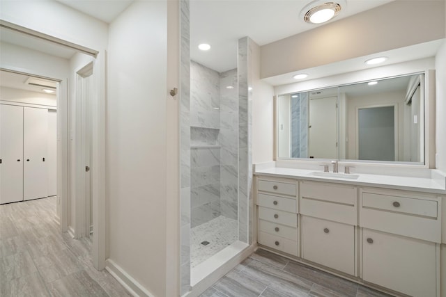 bathroom featuring vanity and a tile shower