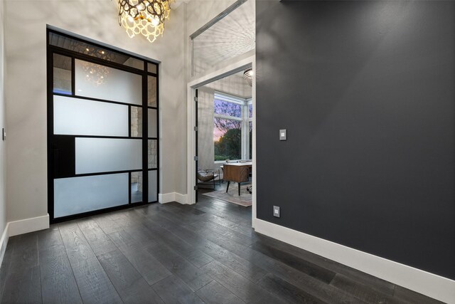 foyer with dark hardwood / wood-style flooring and a notable chandelier