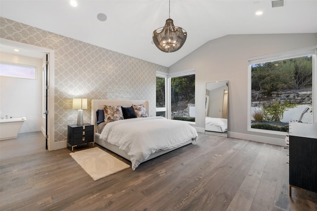 bedroom featuring ensuite bathroom, an inviting chandelier, wood-type flooring, and lofted ceiling