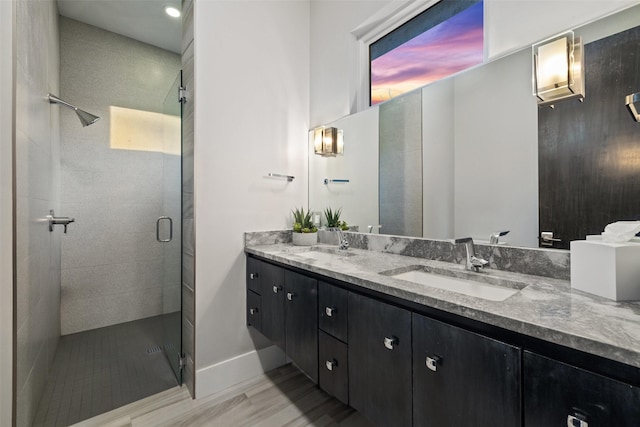 bathroom featuring hardwood / wood-style flooring, vanity, and an enclosed shower