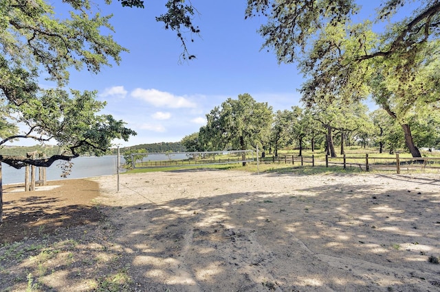 view of yard featuring a water view and volleyball court