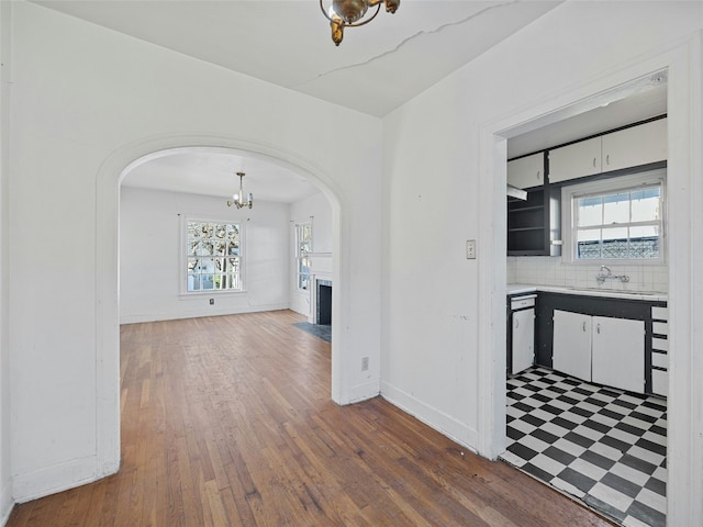 corridor featuring dark wood-type flooring and sink