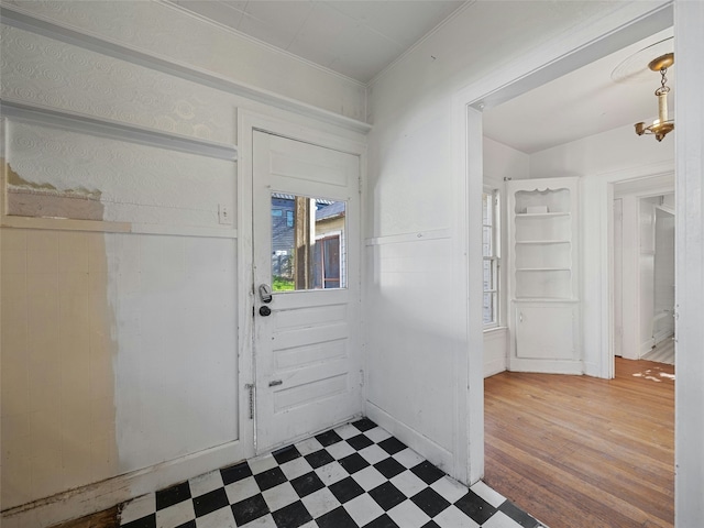 entryway with a chandelier