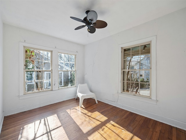 unfurnished room with hardwood / wood-style flooring and ceiling fan