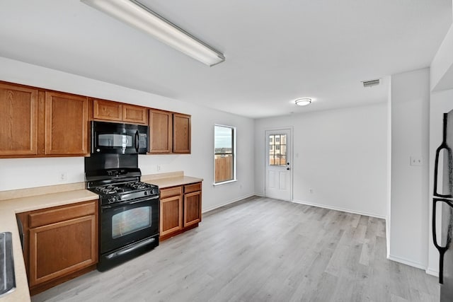 kitchen featuring black appliances and light wood-type flooring