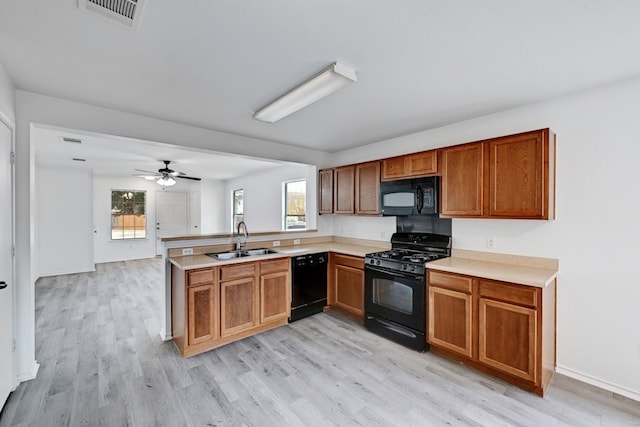 kitchen with black appliances, ceiling fan, plenty of natural light, and sink