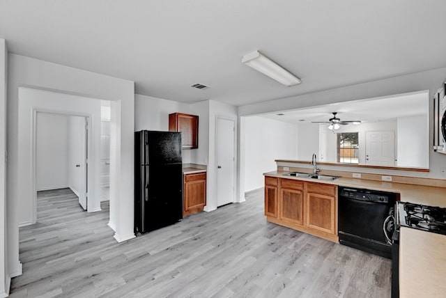 kitchen with ceiling fan, sink, black appliances, and light wood-type flooring