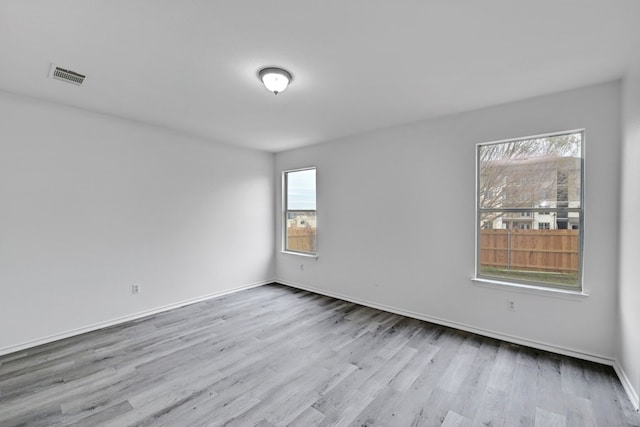 spare room featuring light hardwood / wood-style floors