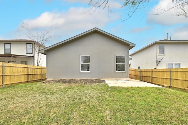 rear view of house with a yard and a patio