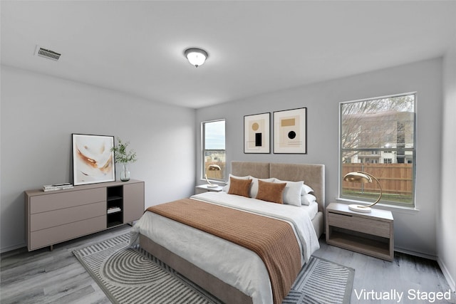 bedroom featuring light wood-type flooring and multiple windows